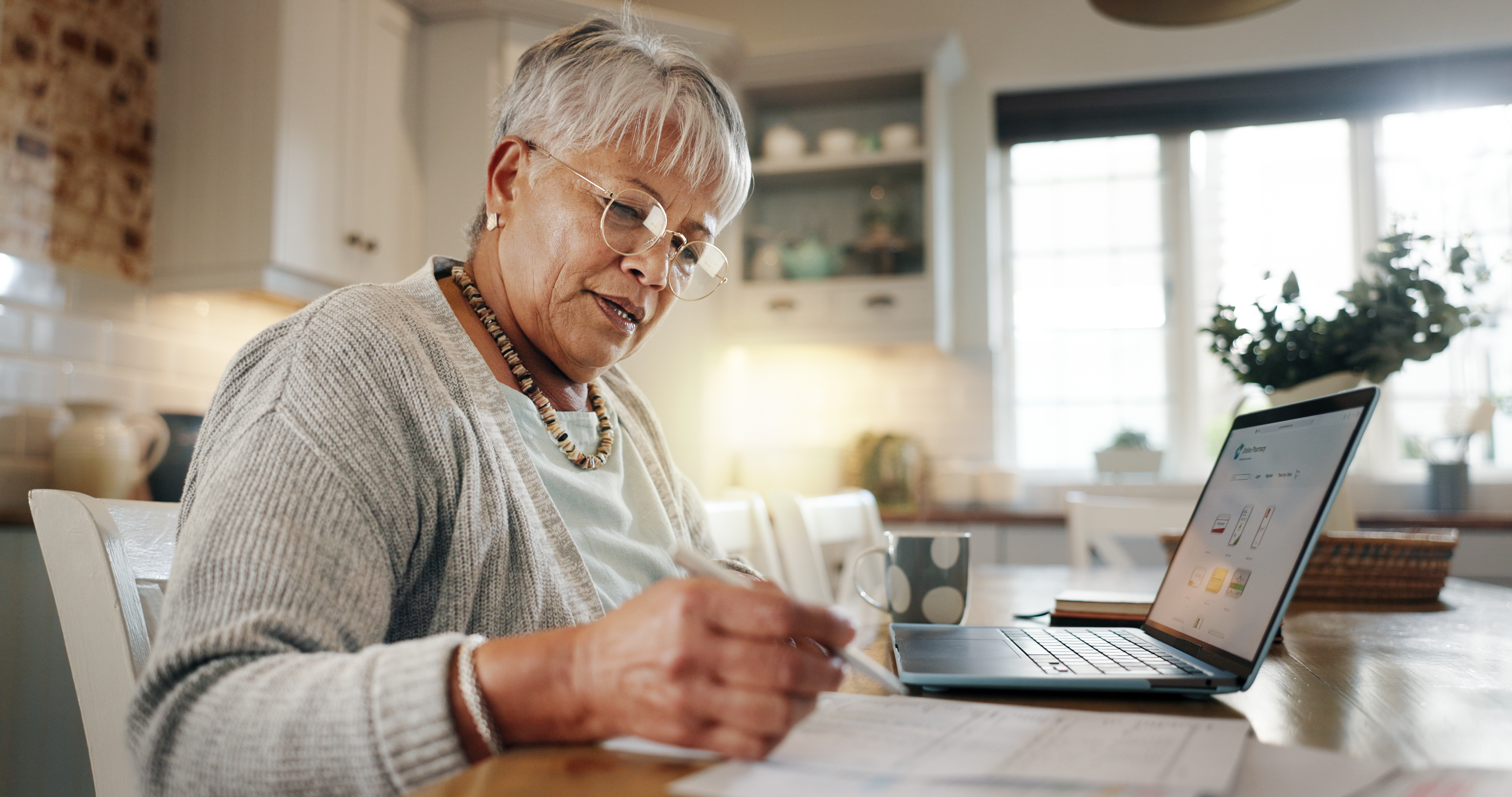 older woman working at a laptop