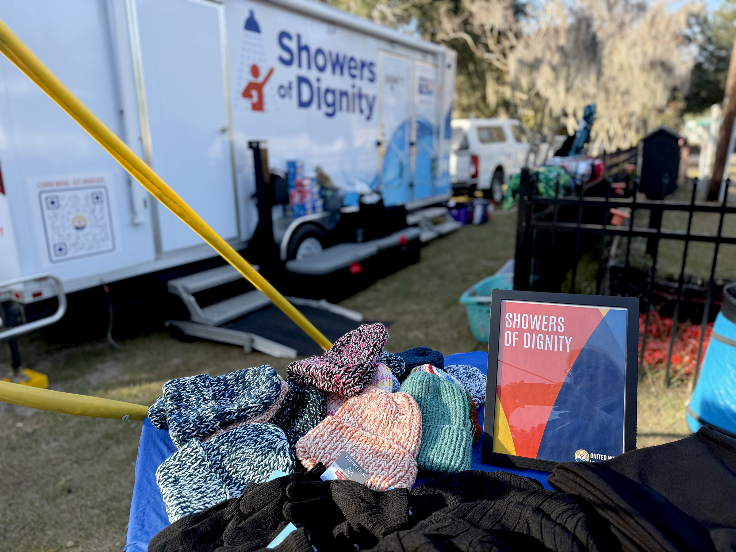 beanies given to showers of dignity patrons along with a photo of showers of dignity trailer