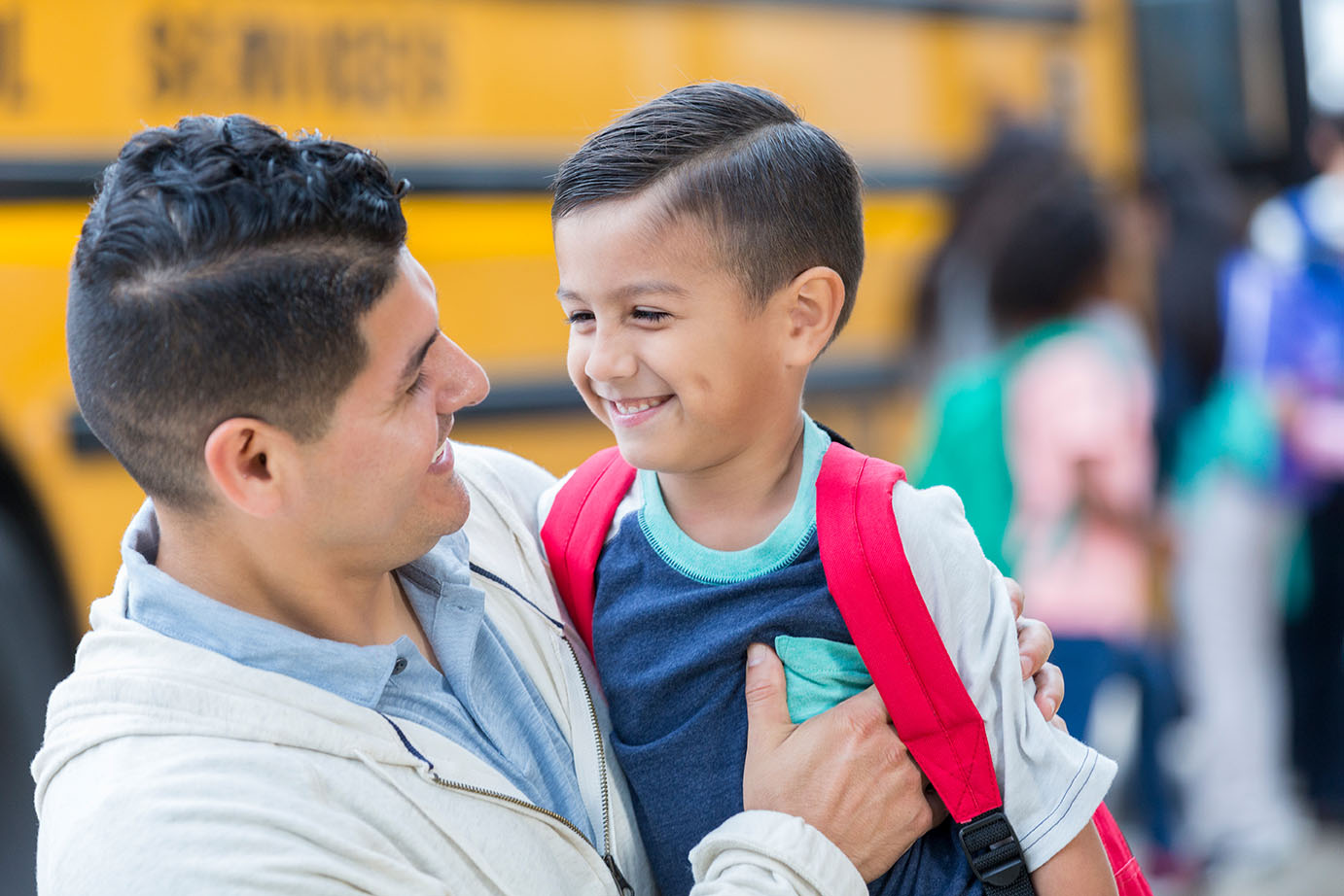 dad and son at the school bus