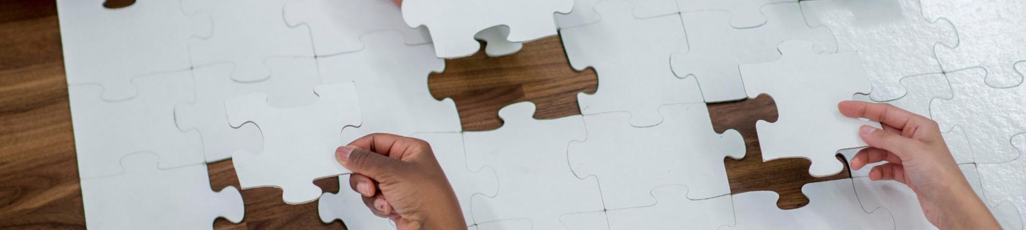 puzzle pieces and hands 